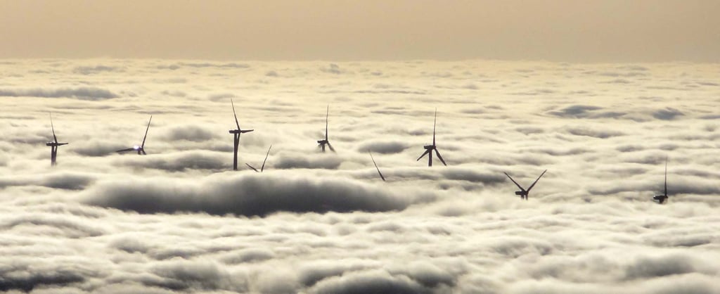 Wind turbines protruding above clouds