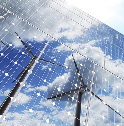 Wind turbines reflected in solar panels