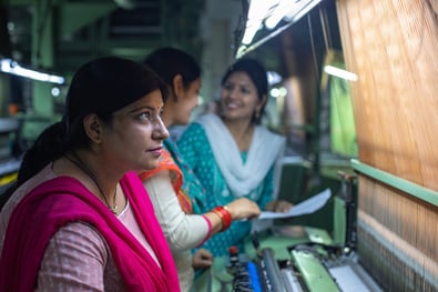 Image of people working in a clothing factory