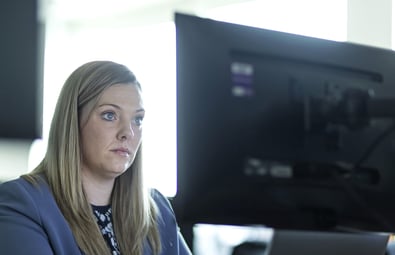 Image of an LRQA cyber security expert looking at computer monitor