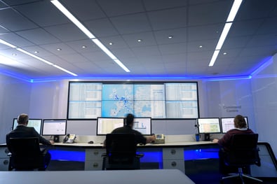 Image of a cyber security team monitoring computer screens