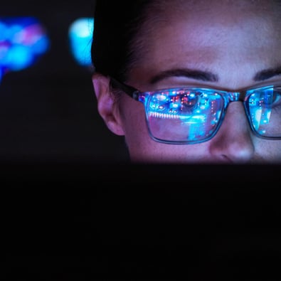 Woman with glasses looking at laptop v2