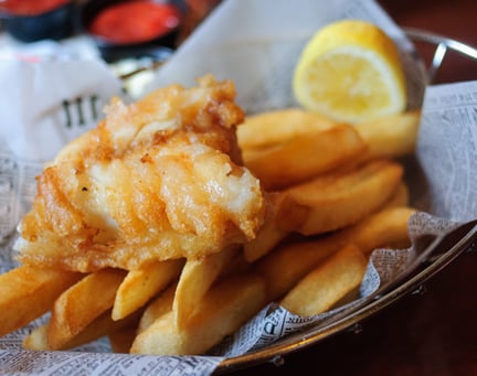 Fish and chips with lemon in newspaper