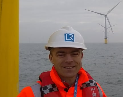 Mark Spring in front of an offshore wind farm