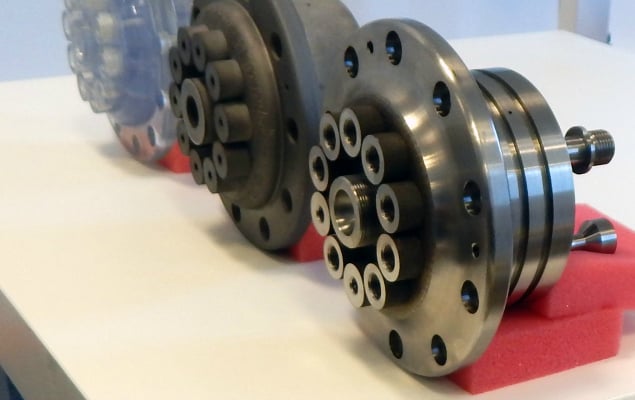 From left to right, Safer Plug’s gateway manifold is show in three states of manufacture: Transparent stereolithographic prototype, additively manufactured in titanium but not machined, and the final, machined titanium part.