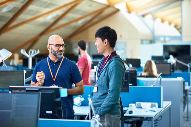 Image of two cyber security experts chatting in an office