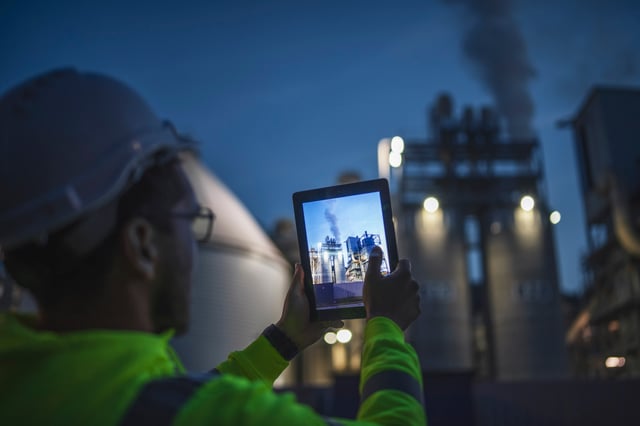 An assessor capturing a photograph of a nuclear plant