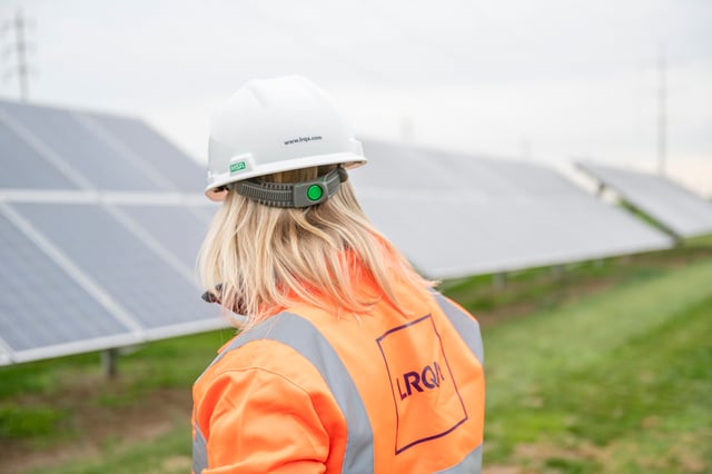 LRQA engineer looking at solar panels